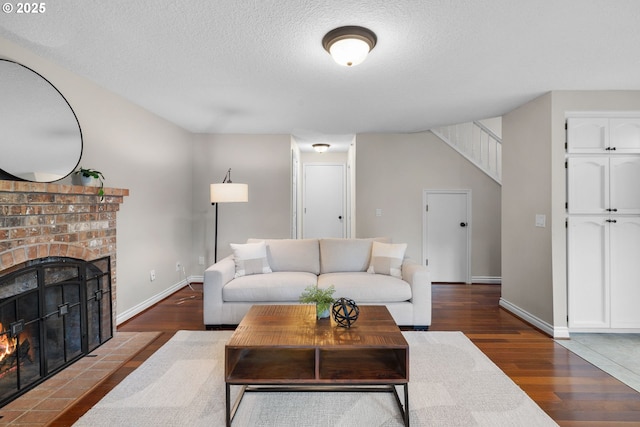 15421 SW Thurston Ln, Portland, OR 97224 - living area with dark wood-type flooring, a brick fireplace, baseboards, and a textured ceiling