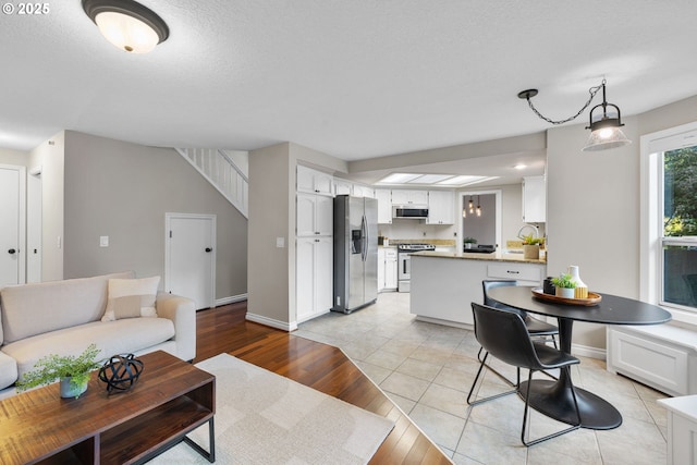 15421 SW Thurston Ln, Portland, OR 97224 - living area featuring light wood-style flooring and baseboards