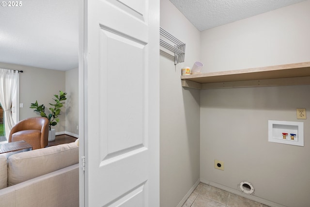 15421 SW Thurston Ln, Portland, OR 97224 - washroom with electric dryer hookup, washer hookup, baseboards, a textured ceiling, and light tile patterned floors