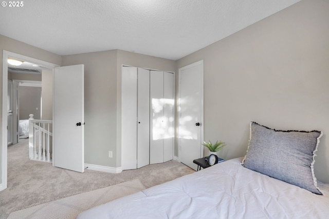 15421 SW Thurston Ln, Portland, OR 97224 - carpeted bedroom with a closet, baseboards, and a textured ceiling