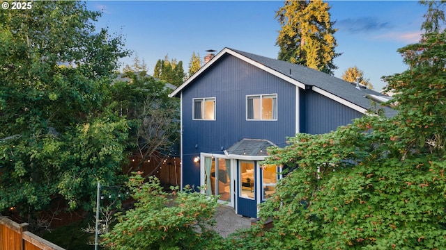 15421 SW Thurston Ln, Portland, OR 97224 - back of house with a chimney and roof with shingles