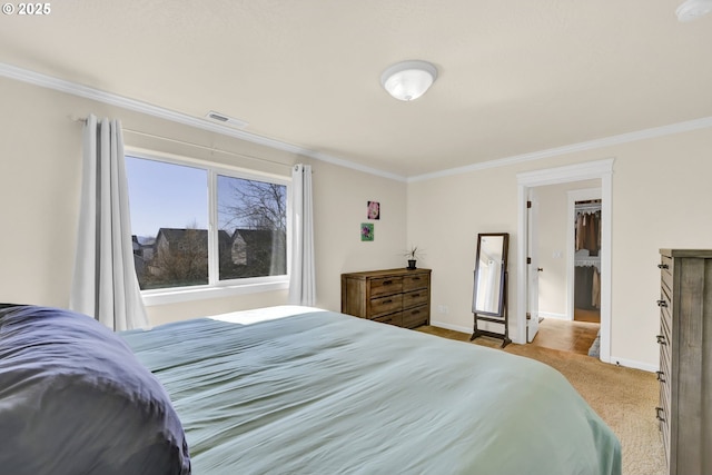 bedroom with carpet, visible vents, crown molding, and baseboards