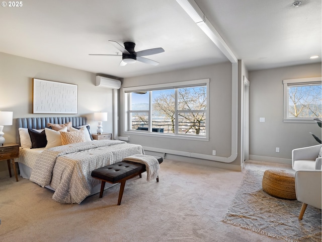 carpeted bedroom with a wall unit AC, ceiling fan, and baseboards