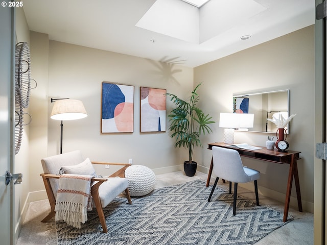 carpeted office with a skylight and baseboards