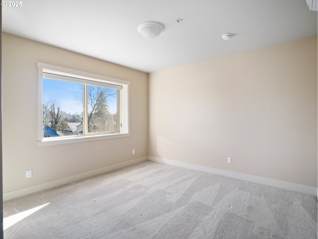 empty room featuring carpet flooring and baseboards