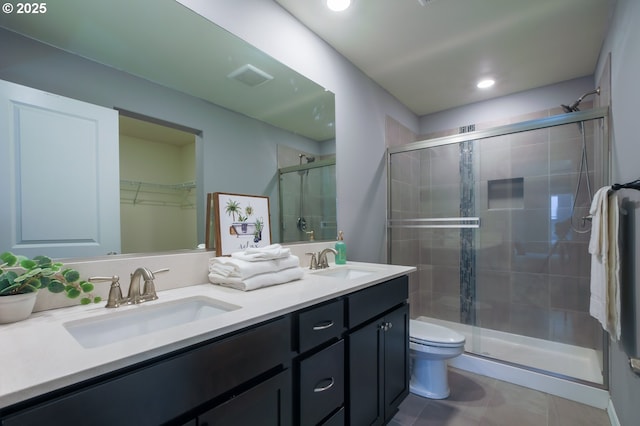 bathroom featuring walk in shower, vanity, and toilet