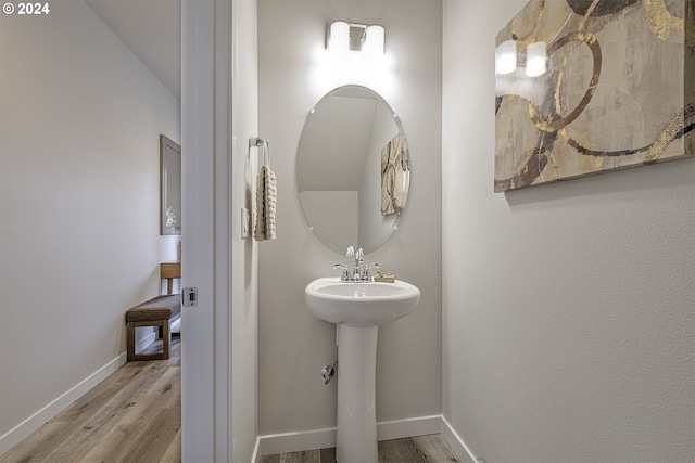 bathroom with hardwood / wood-style flooring and sink