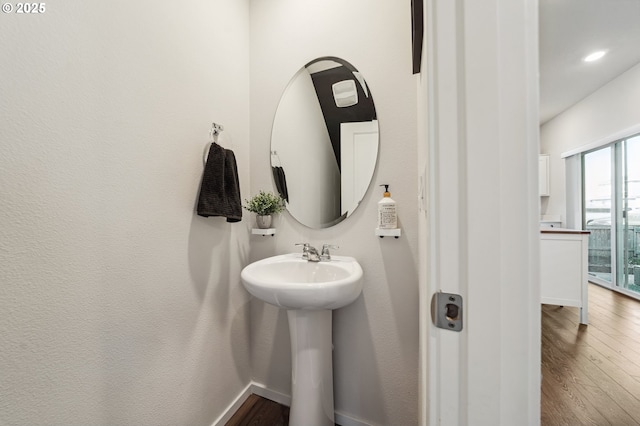 bathroom featuring recessed lighting, baseboards, and wood finished floors