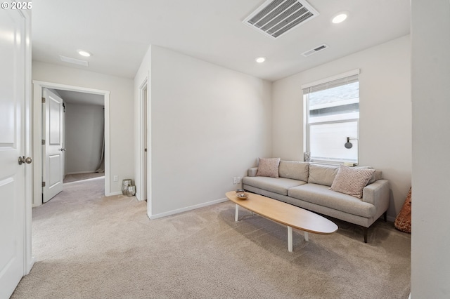 living area with light carpet, baseboards, visible vents, and recessed lighting