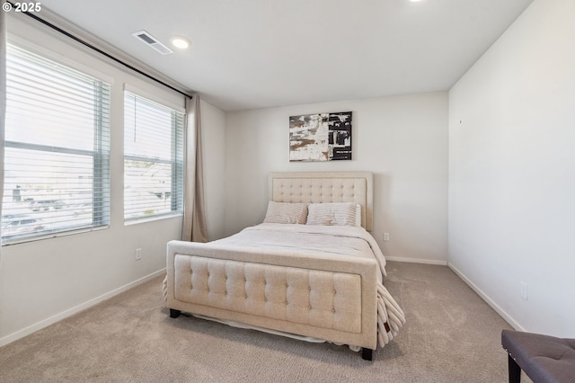 bedroom with carpet floors, baseboards, and visible vents