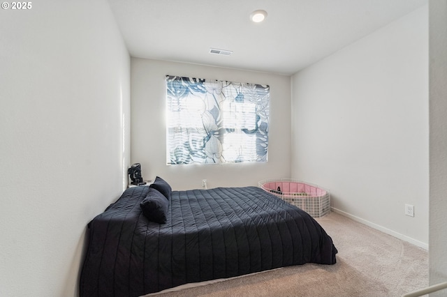 carpeted bedroom with baseboards and visible vents