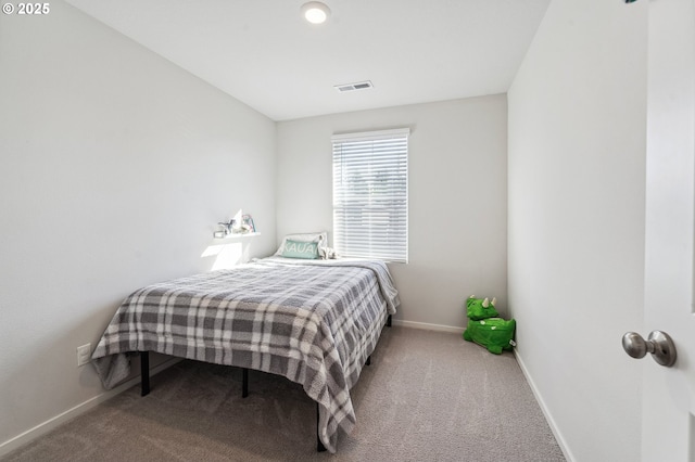 bedroom featuring carpet floors, visible vents, and baseboards