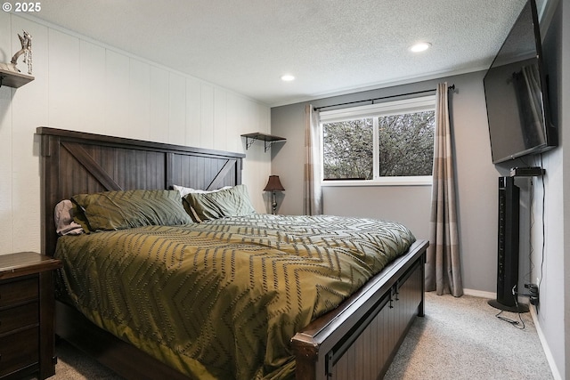 bedroom featuring light carpet, recessed lighting, a textured ceiling, and baseboards