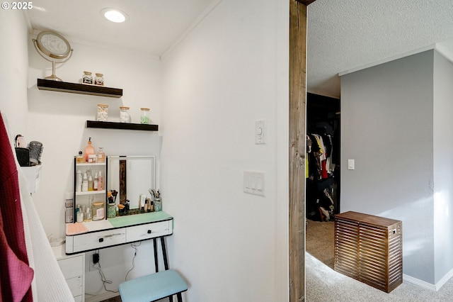 bar featuring ornamental molding, a textured ceiling, carpet floors, baseboards, and a dry bar