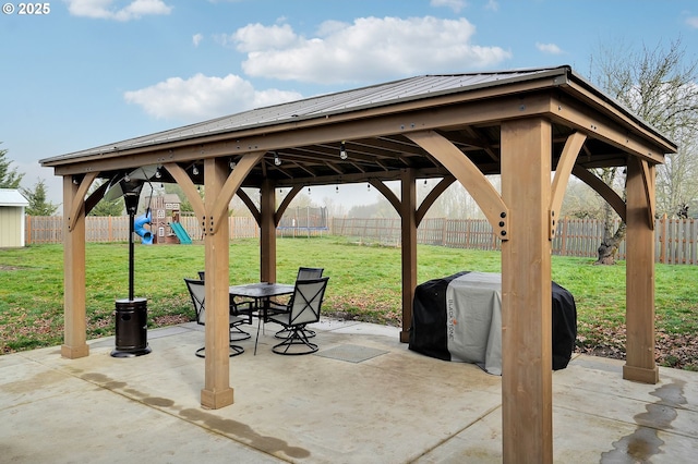 view of patio featuring area for grilling, a playground, a trampoline, and a fenced backyard