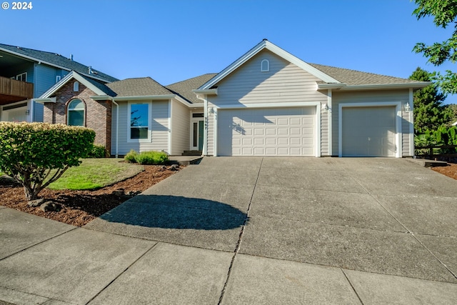 single story home with an attached garage and concrete driveway