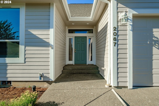 entrance to property featuring an attached garage