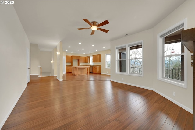 6018 Fernhill Loop, Springfield, OR 97478 - unfurnished living room featuring a ceiling fan, baseboards, recessed lighting, and wood finished floors