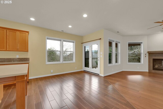 6018 Fernhill Loop, Springfield, OR 97478 - unfurnished living room featuring a fireplace, baseboards, wood finished floors, recessed lighting, and a ceiling fan