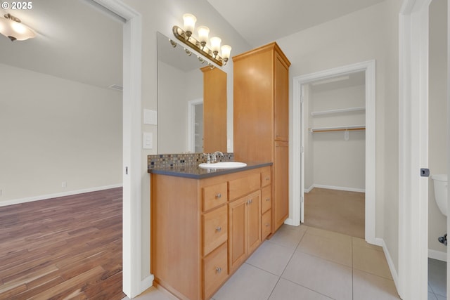 6018 Fernhill Loop, Springfield, OR 97478 - bathroom featuring vanity, baseboards, and wood finished floors