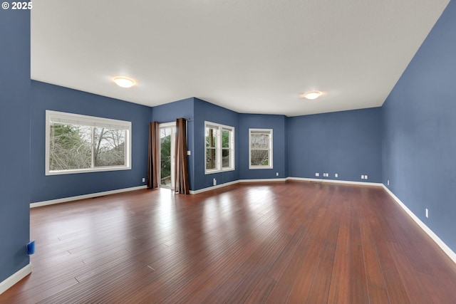 6018 Fernhill Loop, Springfield, OR 97478 - unfurnished living room featuring baseboards and wood finished floors