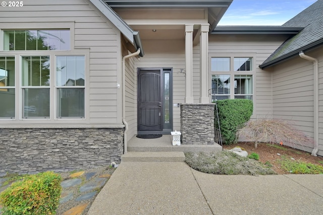 view of exterior entry featuring stone siding