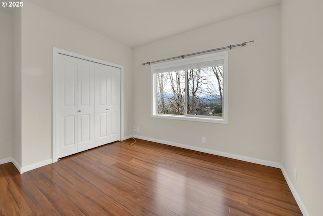 6018 Fernhill Loop, Springfield, OR 97478 - unfurnished bedroom featuring wood finished floors, baseboards, and a closet
