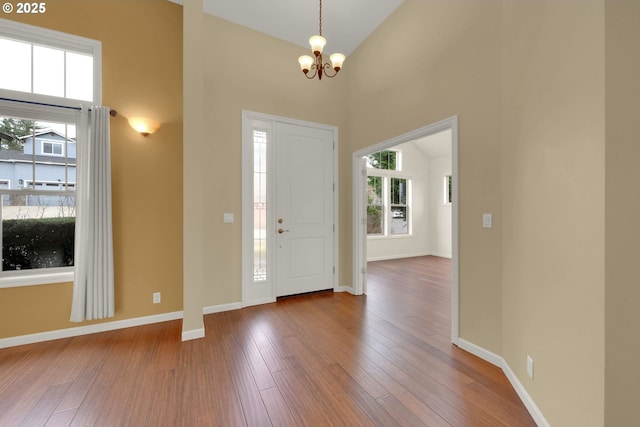 6018 Fernhill Loop, Springfield, OR 97478 - foyer entrance featuring plenty of natural light, a chandelier, hardwood / wood-style floors, baseboards, and a towering ceiling