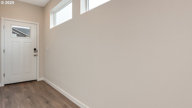 doorway to outside with baseboards and dark wood-style flooring