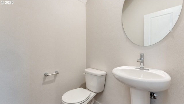 bathroom featuring toilet and a sink