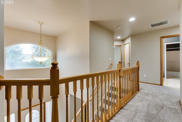 hall featuring light colored carpet