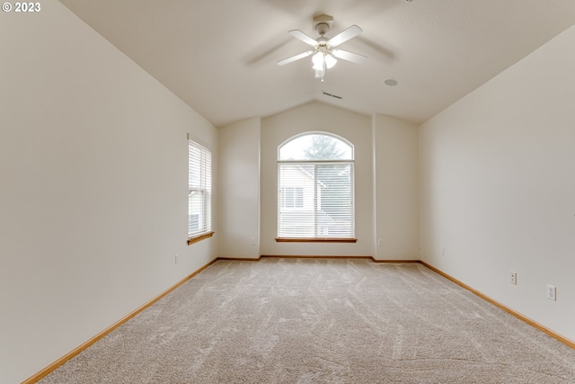 unfurnished room featuring vaulted ceiling, ceiling fan, and light carpet