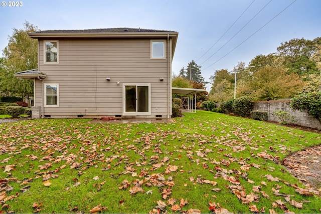 rear view of house featuring a yard