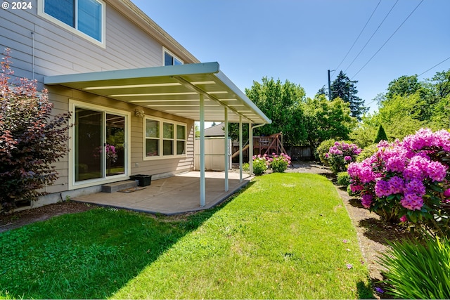 view of yard featuring a patio area and a storage unit