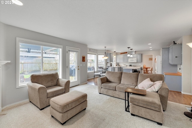 living room featuring baseboards and recessed lighting