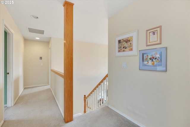 corridor with an upstairs landing, recessed lighting, carpet flooring, baseboards, and visible vents