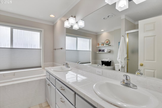 bathroom featuring a shower stall, double vanity, a sink, and a garden tub