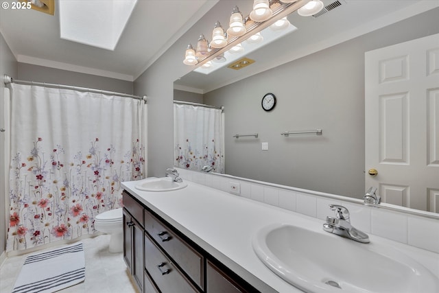 full bath with double vanity, visible vents, toilet, and a sink