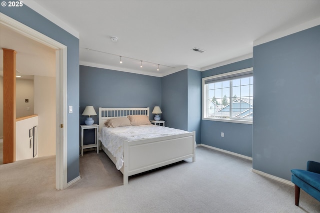 carpeted bedroom featuring baseboards and visible vents