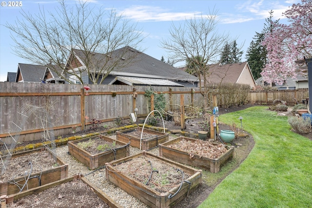 view of yard featuring a vegetable garden and fence