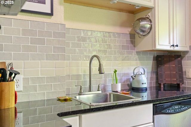 kitchen with dishwasher, a sink, backsplash, and white cabinets