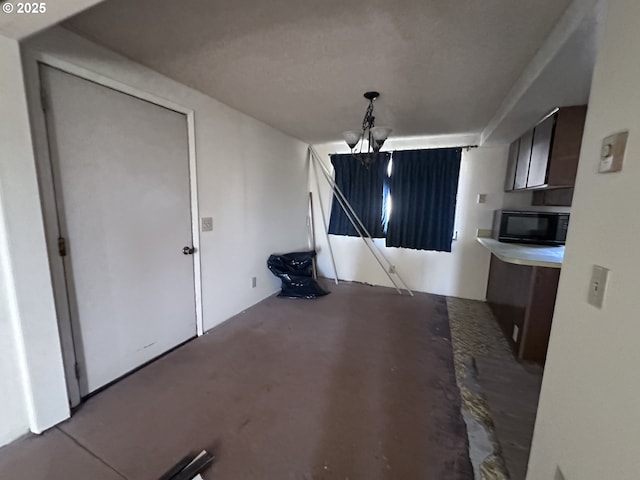 unfurnished dining area featuring a chandelier