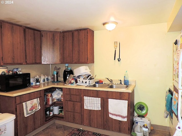 kitchen with dark brown cabinetry and sink