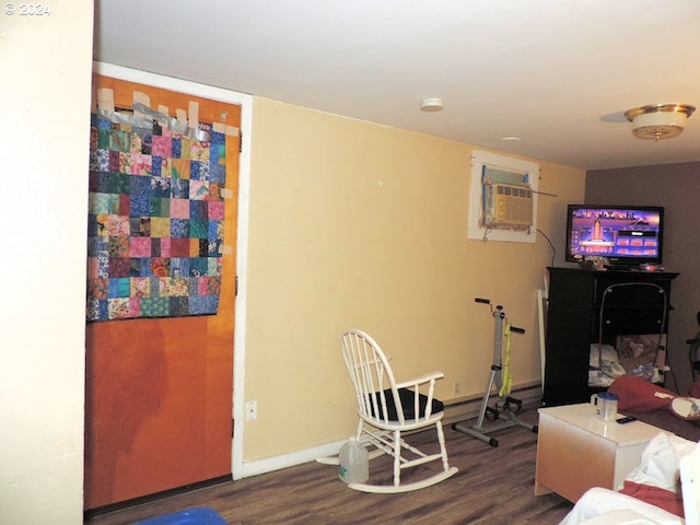 living room with dark hardwood / wood-style floors and a wall mounted AC