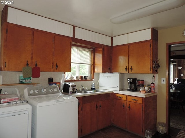 kitchen featuring separate washer and dryer, sink, and backsplash