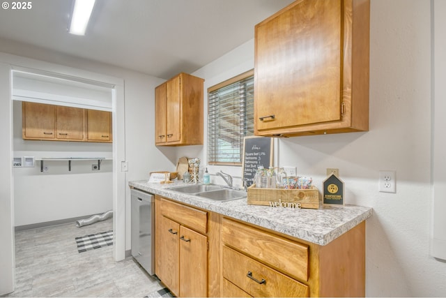 kitchen featuring brown cabinetry, light countertops, dishwasher, and a sink