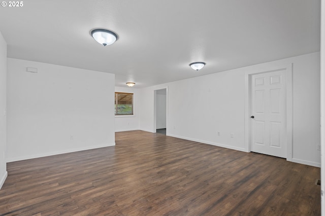 empty room featuring dark wood-type flooring