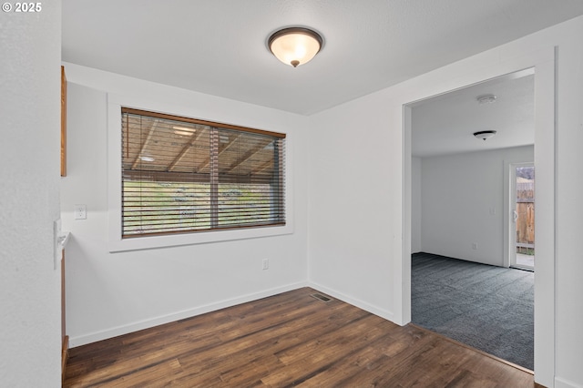 spare room with dark hardwood / wood-style floors