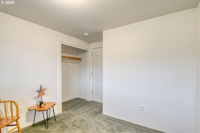 carpeted bedroom featuring a closet and a textured ceiling