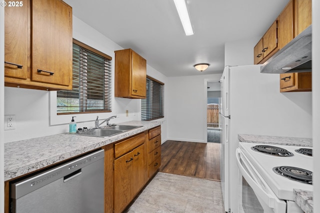 kitchen featuring stainless steel dishwasher, sink, and white range with electric stovetop